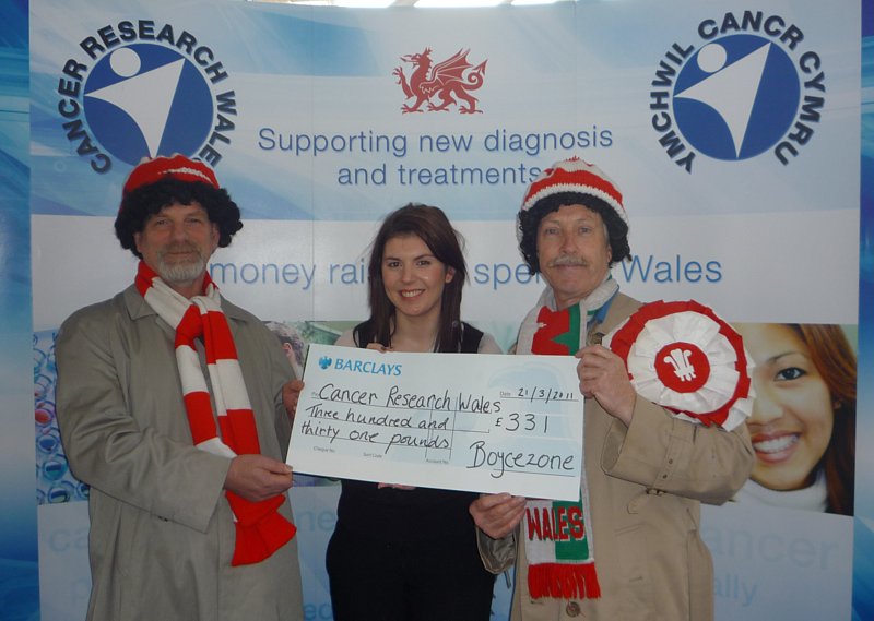 Hugh and Pete from Boycezone presenting a collection cheque to Laura from Cancer Reaearch Wales.
